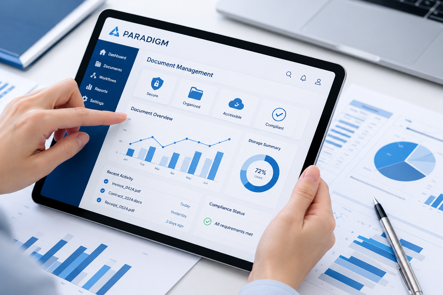 Reviewing a document management dashboard on a tablet beside financial reports