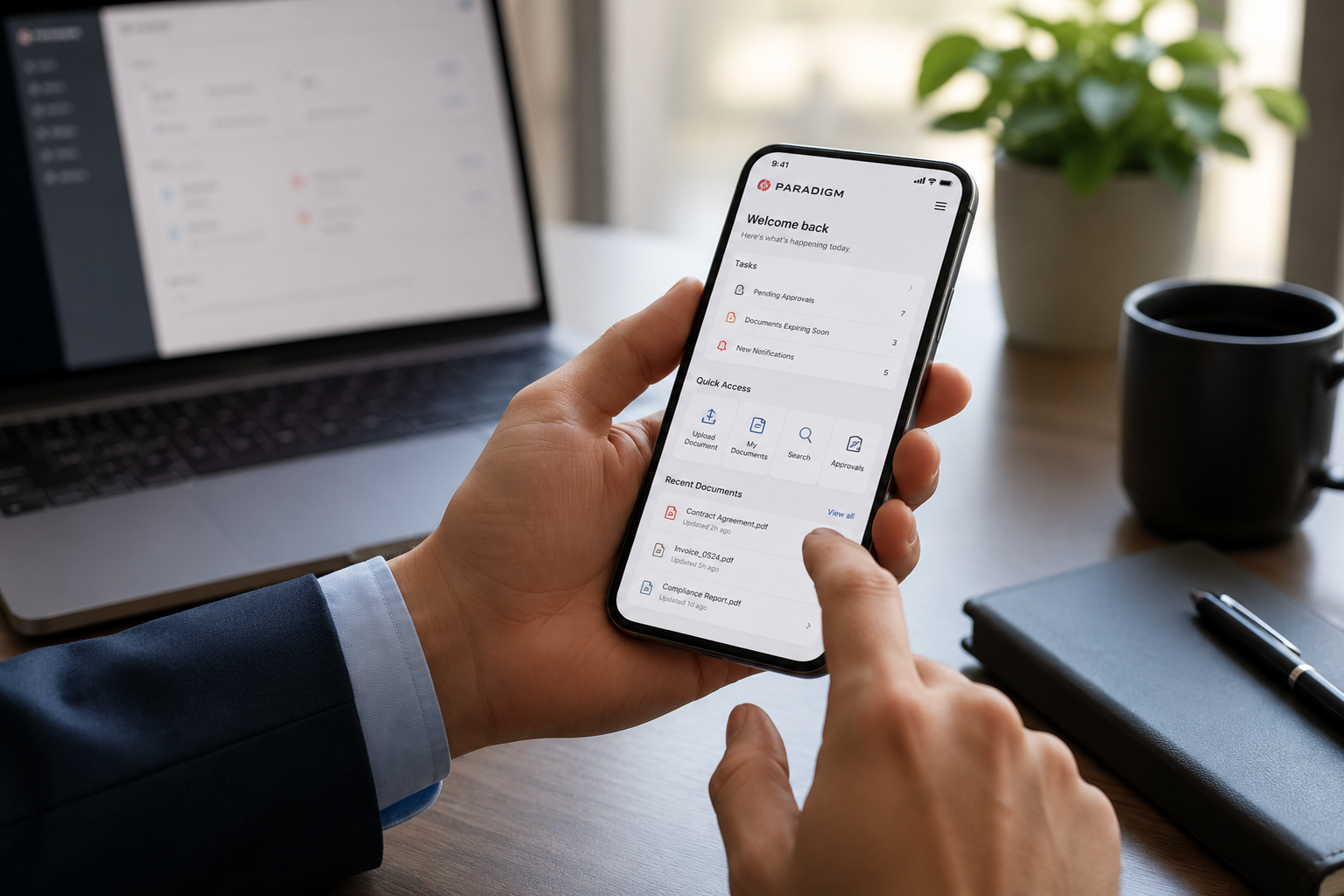 Using a smartphone to review document records beside a desktop computer